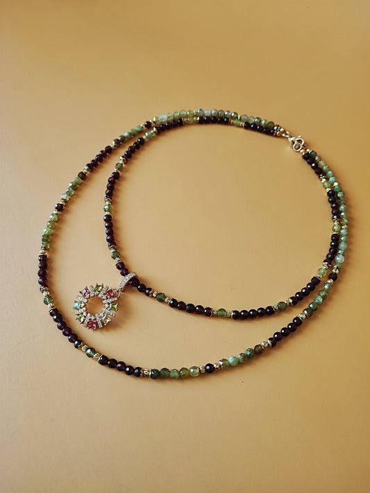 A set of two necklaces and a pendant, handmade with beads of Brazilian Red and green garnet, copper and brass with 24 Carat gold.